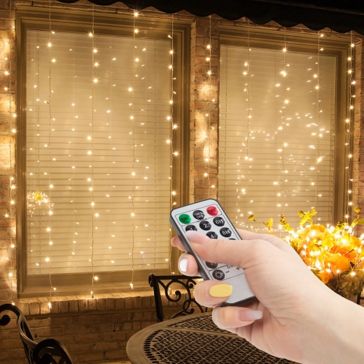 Φωτεινή κουρτίνα με 100 θερμά λευκά LED και τηλεχειριστήριο